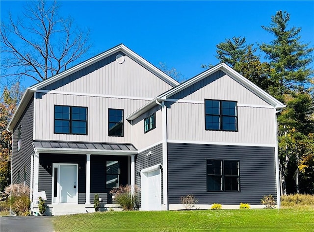 back of house with a porch, a garage, and a lawn