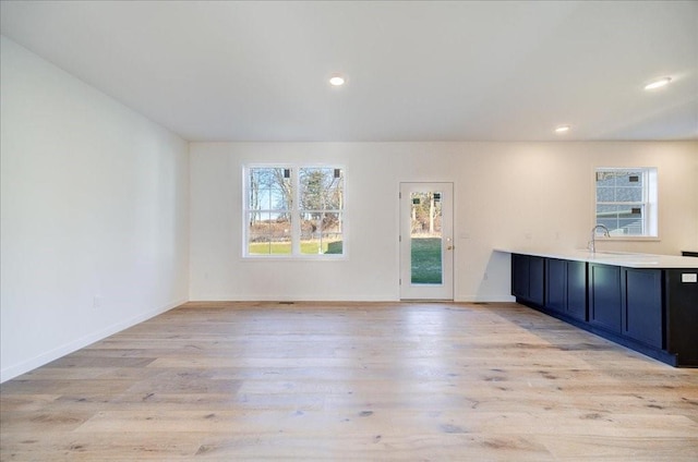 empty room featuring sink and light wood-type flooring