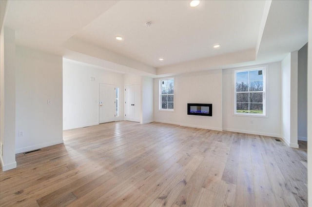 unfurnished living room featuring light hardwood / wood-style flooring