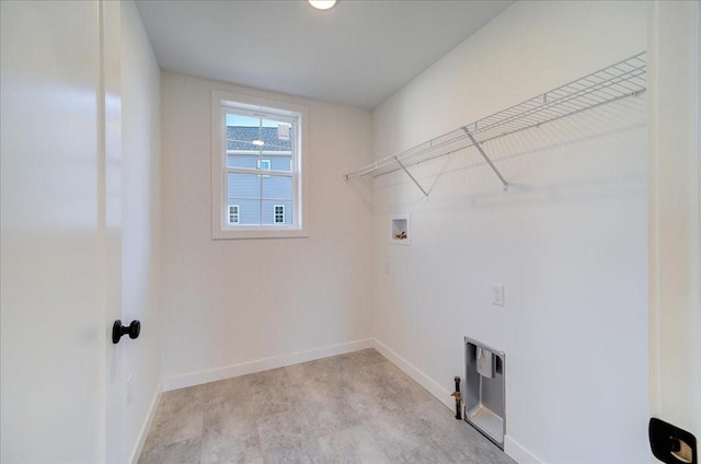 laundry area with hookup for a washing machine and light hardwood / wood-style floors