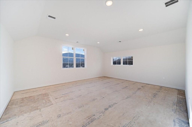 unfurnished room with vaulted ceiling