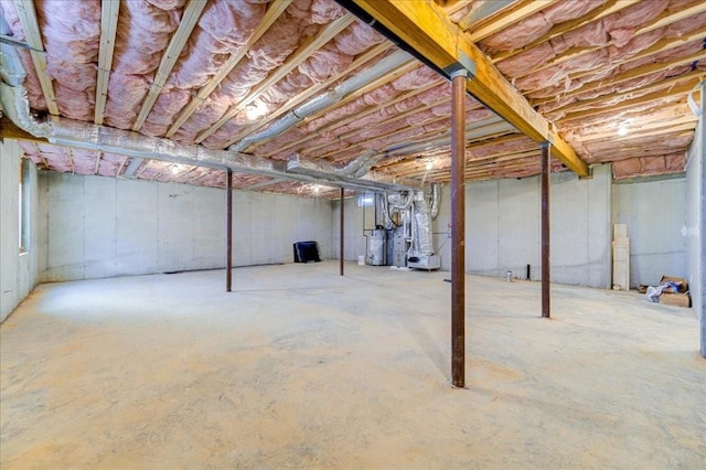 basement featuring heating unit and gas water heater