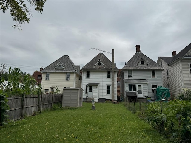 rear view of property featuring a lawn