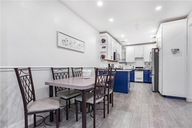 dining room with light hardwood / wood-style flooring