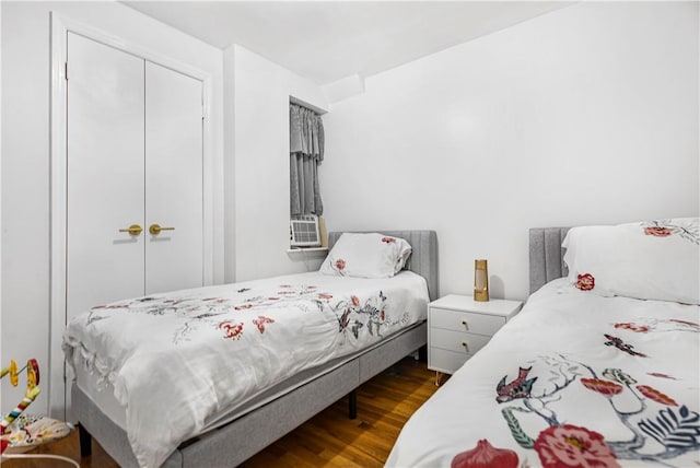 bedroom featuring hardwood / wood-style floors and a closet