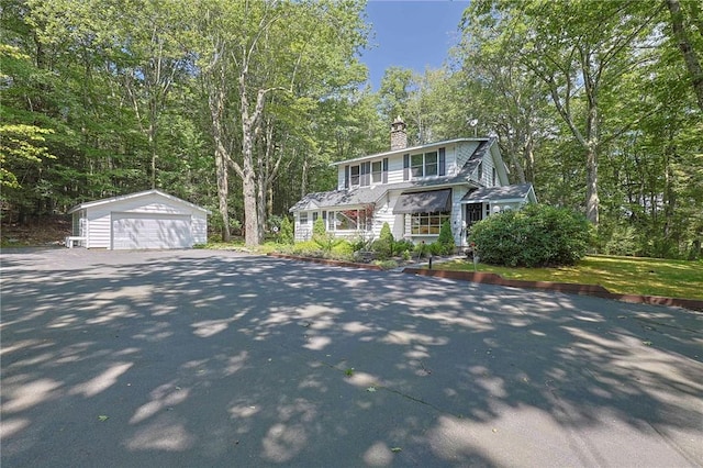 view of front of house featuring a garage and an outdoor structure