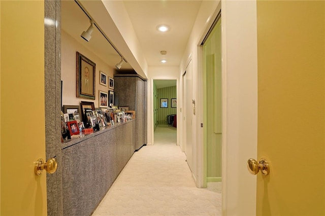 hallway featuring light colored carpet