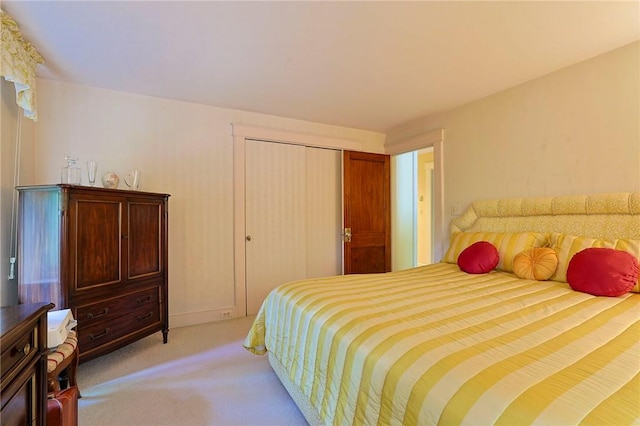 carpeted bedroom featuring a closet