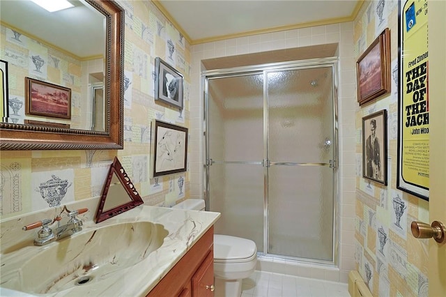 bathroom featuring tile patterned flooring, an enclosed shower, toilet, vanity, and tile walls