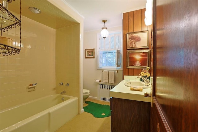 full bathroom with vanity, tiled shower / bath, toilet, ornamental molding, and radiator heating unit