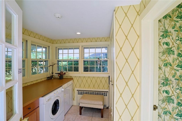 laundry room featuring light tile patterned flooring and radiator