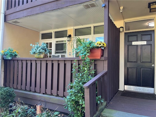 view of exterior entry with a porch