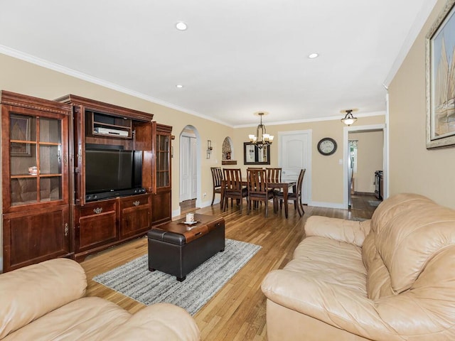 103 Wiltshire Rd Unit D8, Scarsdale, NY 10583 - living room with a chandelier, arched walkways, ornamental molding, light wood finished floors, and recessed lighting