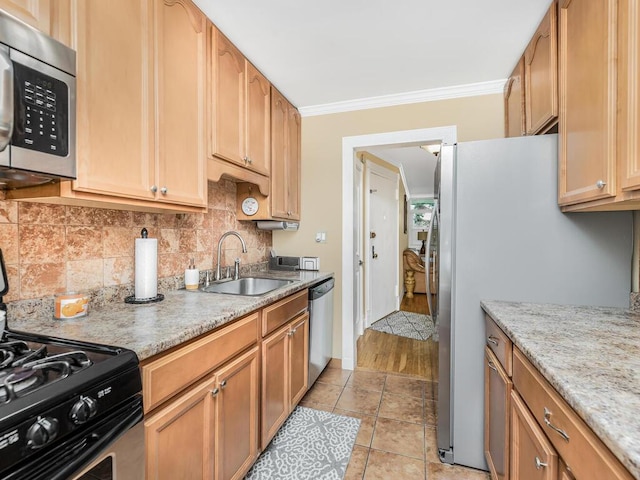 kitchen with decorative backsplash, appliances with stainless steel finishes, crown molding, sink, and light tile patterned floors