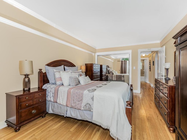 bedroom with crown molding and light hardwood / wood-style flooring