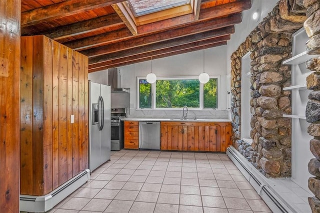 kitchen featuring vaulted ceiling with skylight, baseboard heating, appliances with stainless steel finishes, decorative light fixtures, and light tile patterned flooring