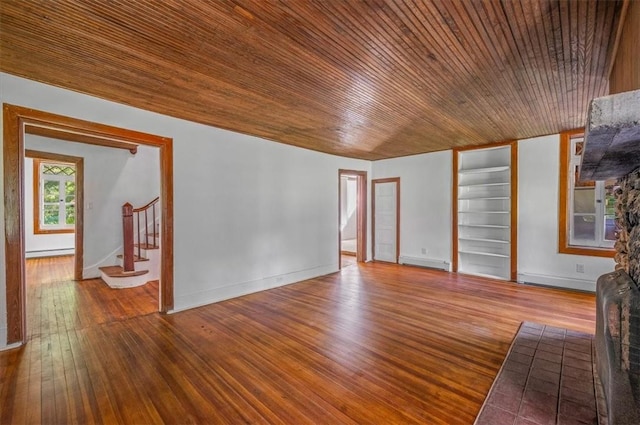 unfurnished living room with hardwood / wood-style flooring, built in features, a baseboard heating unit, and wood ceiling