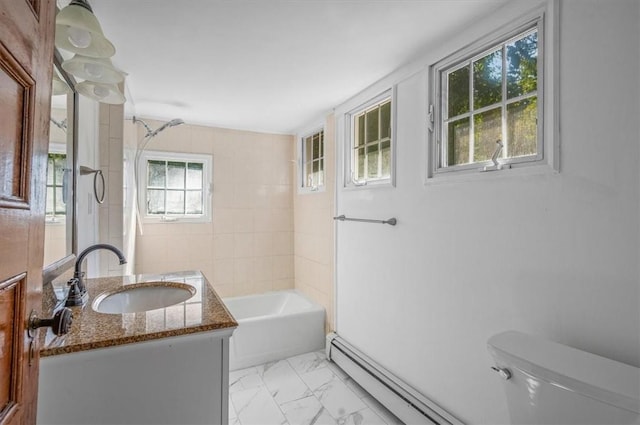 full bathroom featuring vanity, tiled shower / bath combo, toilet, and baseboard heating