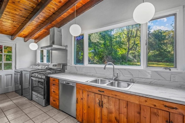 kitchen featuring pendant lighting, ventilation hood, sink, vaulted ceiling with beams, and appliances with stainless steel finishes