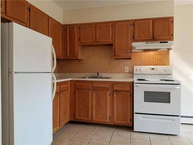 kitchen with light tile patterned flooring, white appliances, sink, and baseboard heating