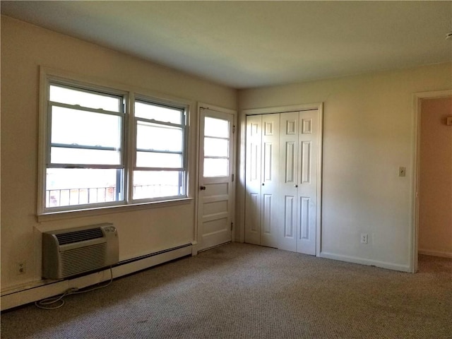 unfurnished bedroom featuring carpet flooring, a closet, baseboard heating, and multiple windows