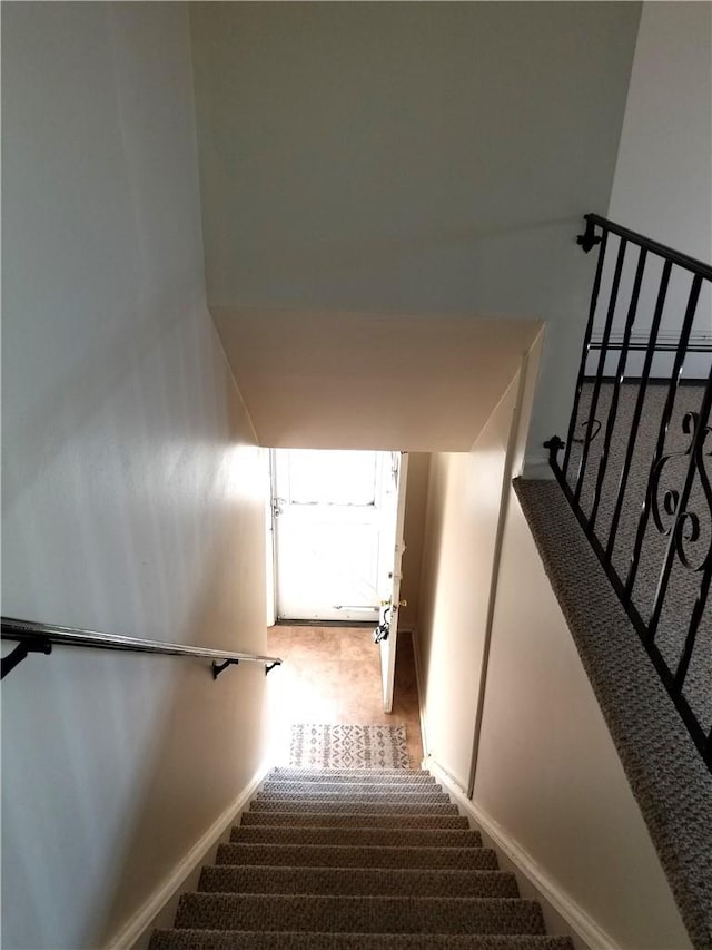 staircase featuring carpet and a baseboard radiator