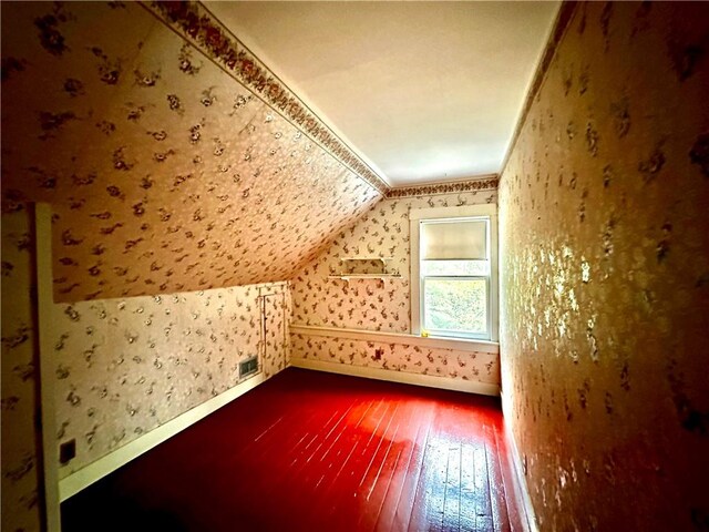 bonus room with hardwood / wood-style flooring and lofted ceiling