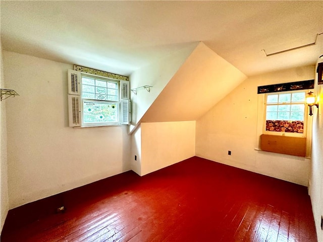 additional living space featuring hardwood / wood-style flooring and vaulted ceiling