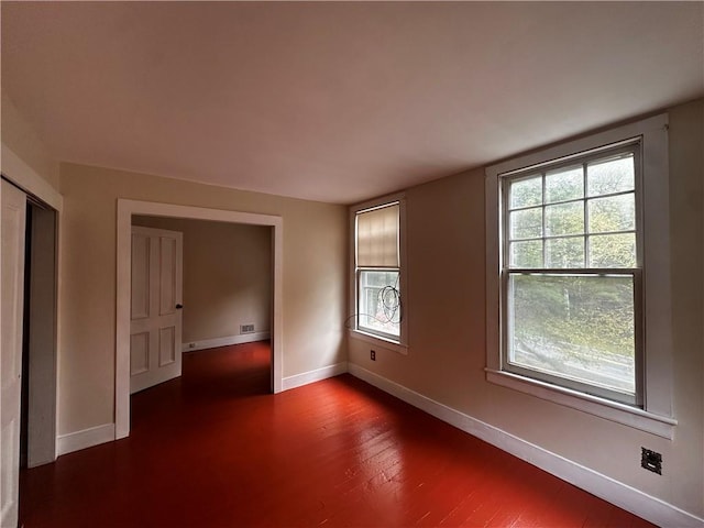 unfurnished room with dark hardwood / wood-style floors