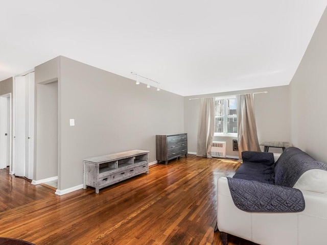 3065 Sedgwick Ave Unit 3A, Bronx, NY 10468 - living area with rail lighting, radiator heating unit, wood finished floors, and baseboards