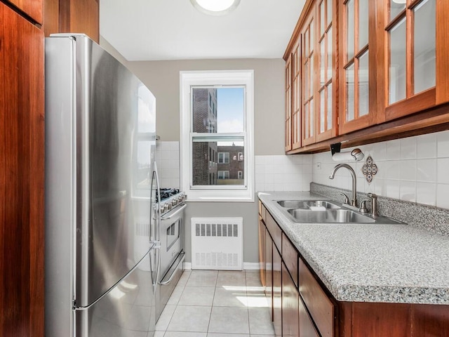 3065 Sedgwick Ave Unit 3A, Bronx, NY 10468 - kitchen with stainless steel appliances, radiator, a sink, and brown cabinets