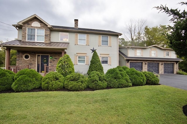 168 S Centerville Rd, Middletown, NY 10940 - view of front facade featuring driveway, an attached garage, a front lawn, a chimney, and a standing seam roof