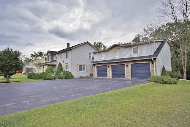 view of front property featuring a front yard and a garage