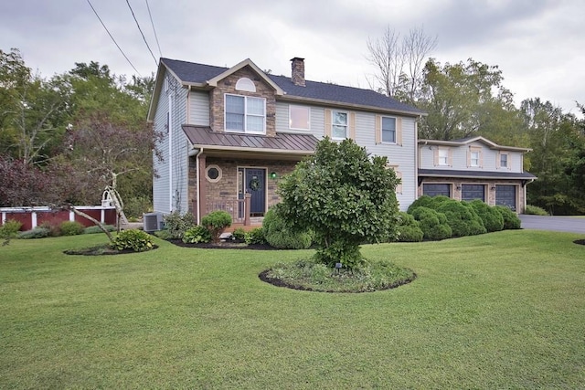 168 S Centerville Rd, Middletown, NY 10940 - view of front of property with a chimney, a front lawn, a garage, a standing seam roof, and asphalt driveway