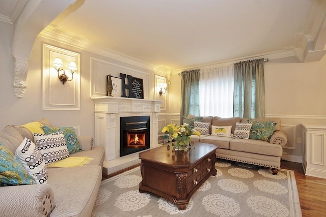 living room featuring light wood-type flooring and crown molding