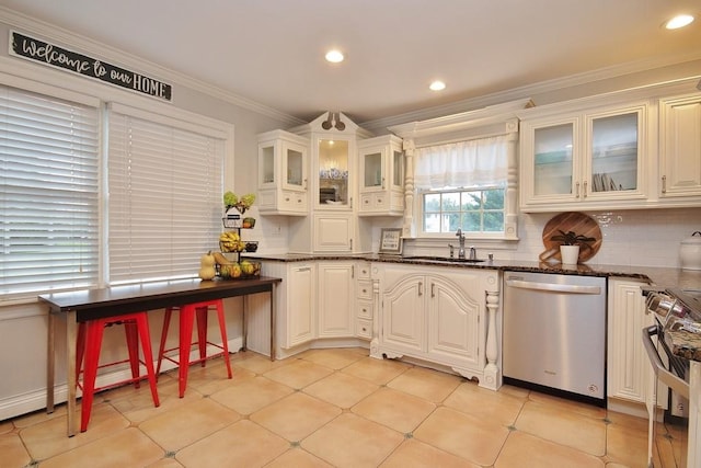 kitchen with stainless steel appliances, white cabinetry, tasteful backsplash, and dark stone countertops