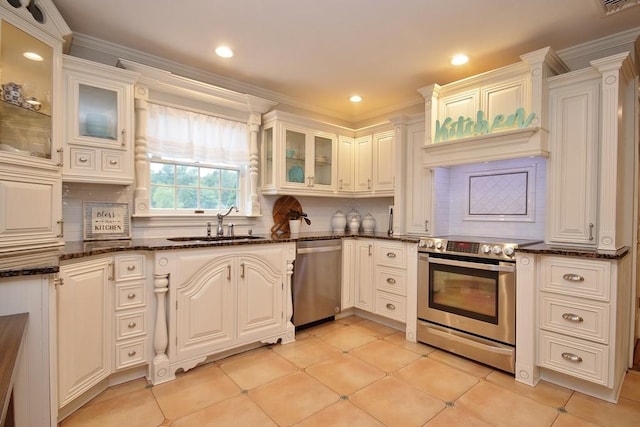 kitchen featuring white cabinets, appliances with stainless steel finishes, and dark stone countertops