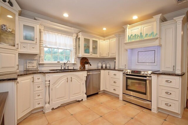 168 S Centerville Rd, Middletown, NY 10940 - kitchen featuring appliances with stainless steel finishes, backsplash, dark stone countertops, recessed lighting, and glass insert cabinets