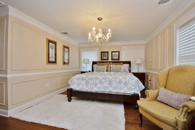 bedroom featuring dark hardwood / wood-style floors, an inviting chandelier, and crown molding