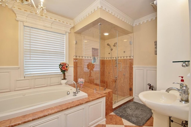 bathroom with ornamental molding, sink, and plus walk in shower