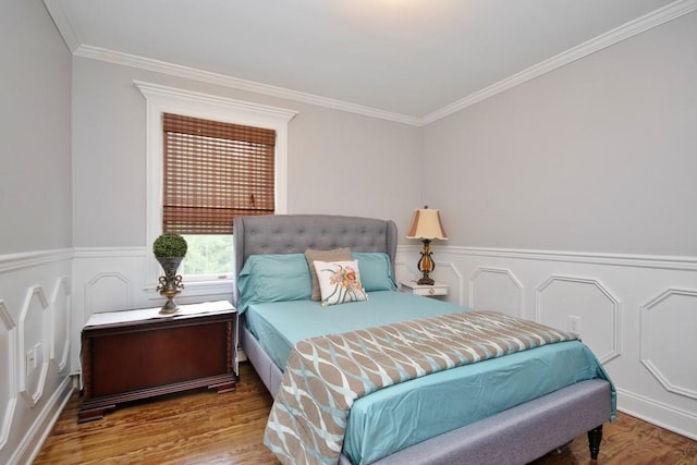 bedroom featuring wood-type flooring and ornamental molding