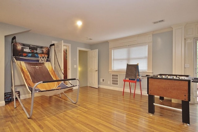 game room with light hardwood / wood-style floors