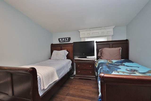 bedroom with dark wood-type flooring