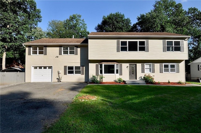 view of front of home with a garage and a front lawn