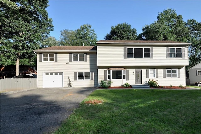 view of front of house featuring a front yard and a garage