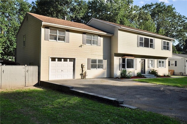 view of front facade with a garage and a front lawn