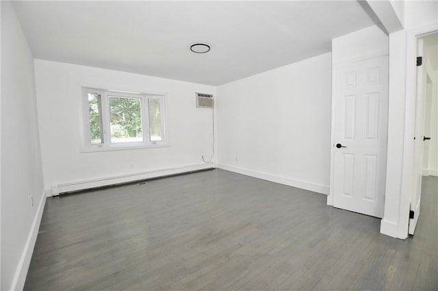 unfurnished room featuring dark hardwood / wood-style flooring, a wall unit AC, and a baseboard heating unit