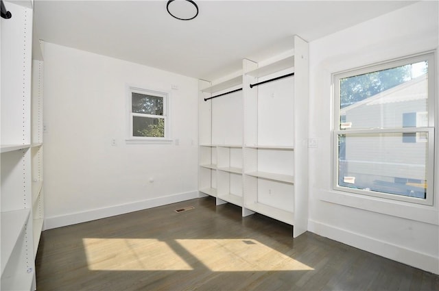 unfurnished bedroom with dark wood-type flooring