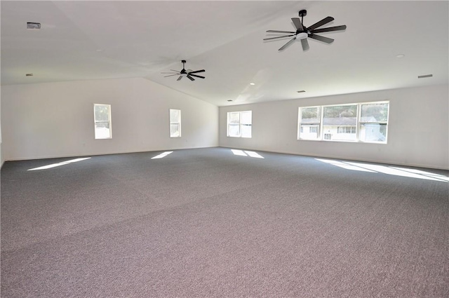 carpeted spare room featuring ceiling fan and vaulted ceiling