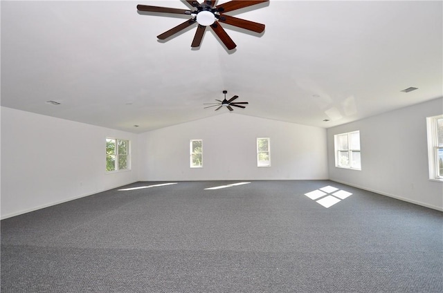 spare room featuring carpet flooring, a wealth of natural light, ceiling fan, and vaulted ceiling